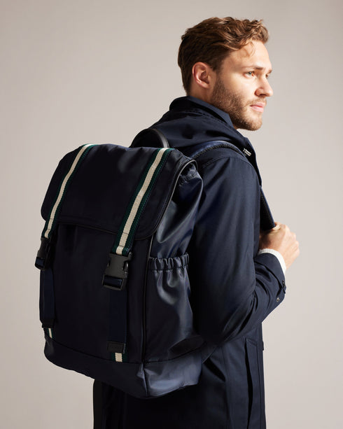 MATEW-Bags-The ultimate backpack for your on-the-go lifestyle, MATEW combines functionality with a bold, fashionable design. Featuring webbing details and side release buckles, this backpack is made to last. The top handle and adjustable shoulder straps make it easy to carry and the elasticated side pocket adds an extra level of convenience. A silicone logo patch finishes the look. The shell fabric of this product is made of 100% recycled polyester. Using recycled polyester helps divert plastic waste from e